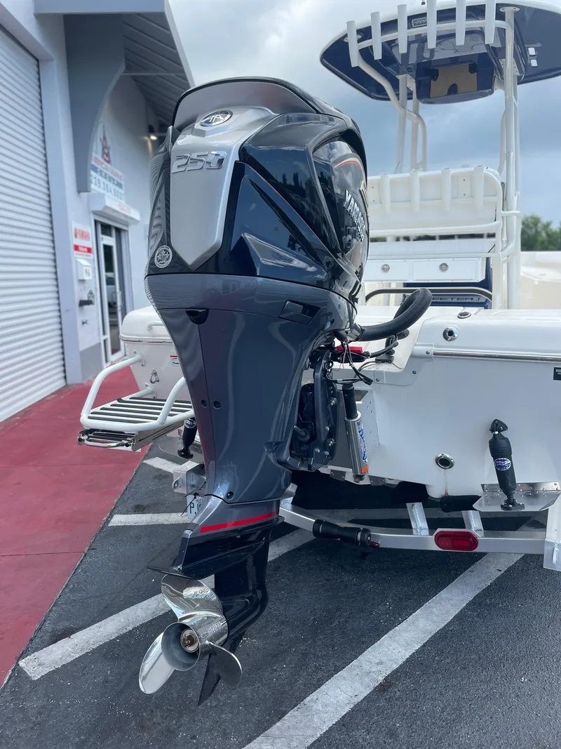 Slide: The Image of 2024 Skeeter SX 2350 boat with powerful outboard motor in a marina setting. - 31