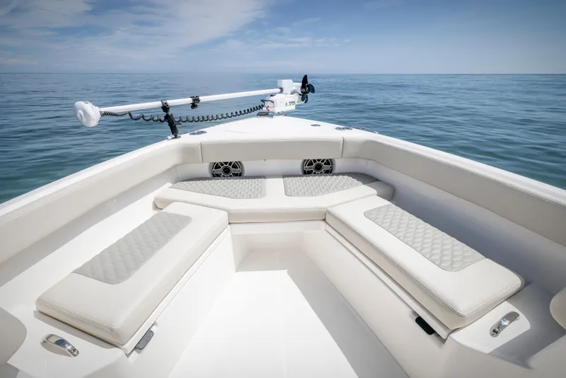 Slide: The Image of Solace 30 HCS 2025 boat interior with cushioned seating and ocean view. - 10