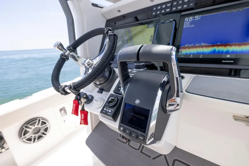 Slide: The Image of 2025 Solace 30 HCS boat dashboard with advanced navigation technology. - 12
