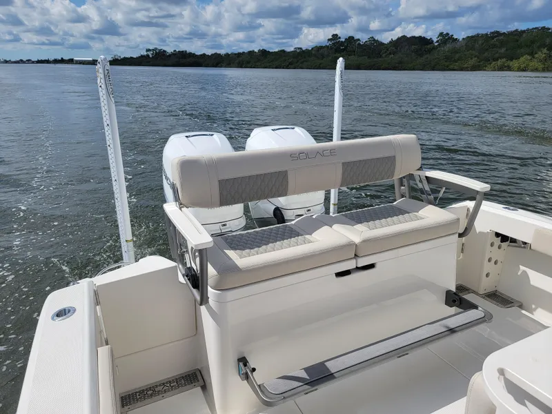Slide: The Image of 2025 Solace 30 HCS boat with dual engines on a calm river. - 7