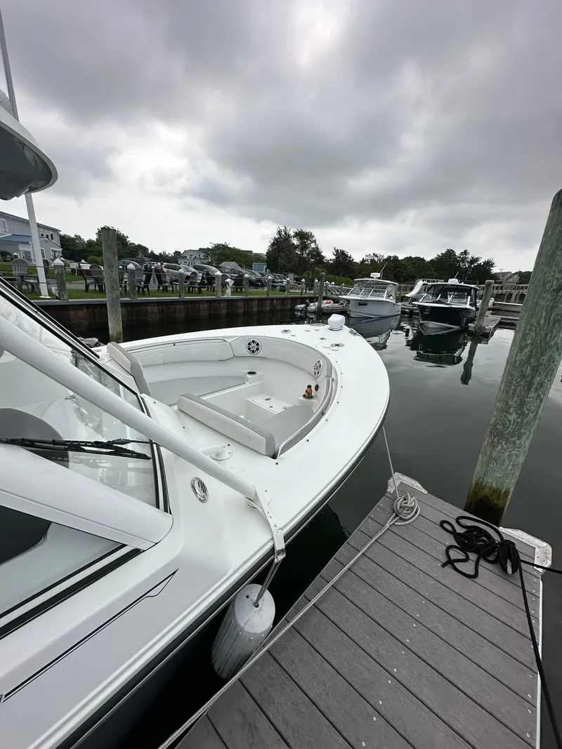 Slide: The Image of Parker 2540 DC 2021 boat docked at marina under cloudy sky. - 4