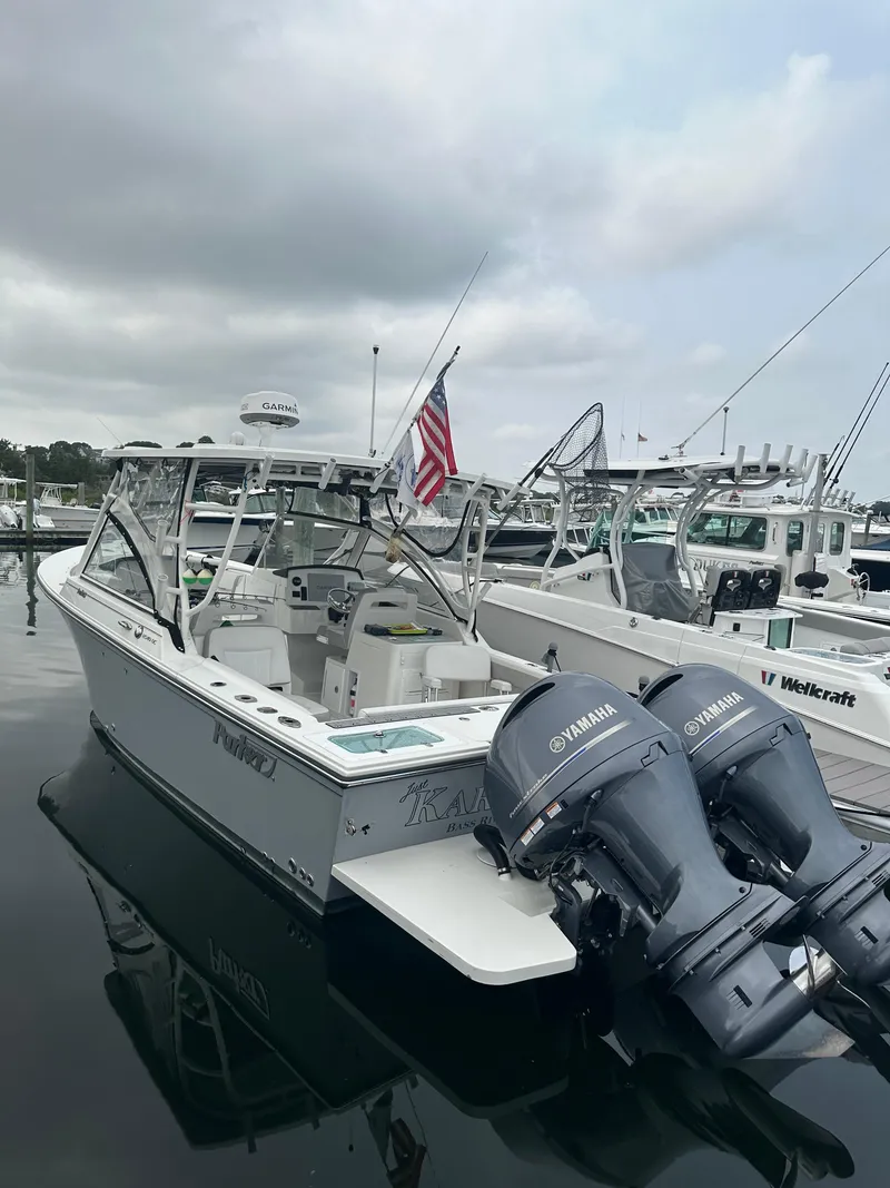 Slide: The Image of 2021 Parker 2540 DC boat with dual Yamaha engines docked at marina. - 7