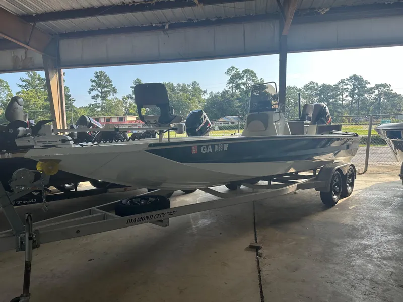The Image of 2018 Excel 220 Bay Pro boat on trailer in covered storage area. - 1