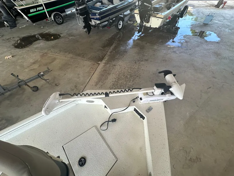 Slide: The Image of 2018 Excel 220 Bay Pro boat with trolling motor in a garage setting. - 5