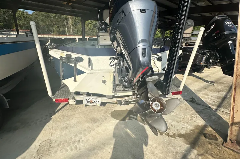 Slide: The Image of 2018 Excel 220 Bay Pro boat with powerful outboard motor in storage. - 7