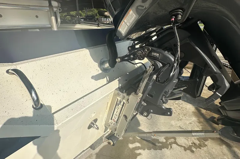 Slide: The Image of 2018 Excel 220 Bay Pro boat motor and transom detail in sunlight. - 8