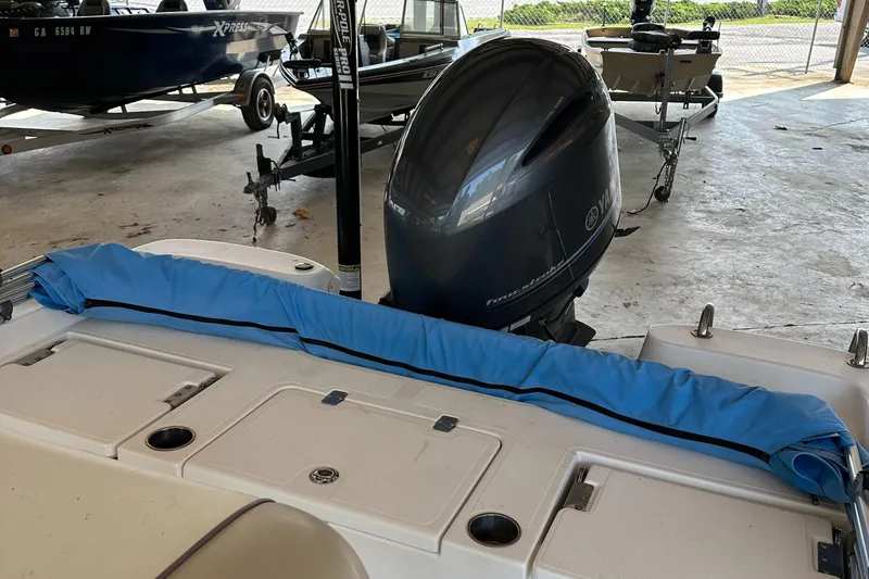 Slide: The Image of 2018 Excel 220 Bay Pro boat with outboard motor in storage. - 9