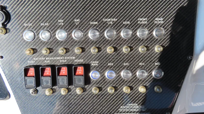 Slide: The Image of 2014 Sunsation 34 CCX boat interior with luxurious gray and red seating, steering wheel, and controls. - 11