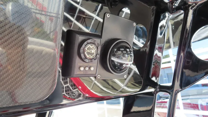 Slide: The Image of 2014 Sunsation 34 CCX boat dashboard with compass and electronic controls. - 12