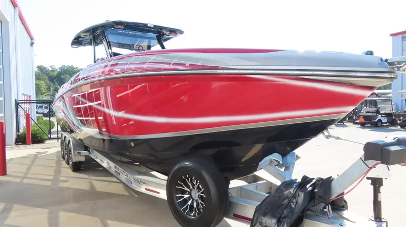 Slide: The Image of 2014 Sunsation 34 CCX boat in vibrant red on a trailer, outdoors. - 3