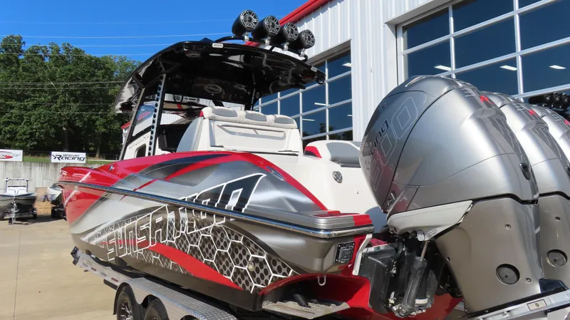 Slide: The Image of 2014 Sunsation 34 CCX with triple Mercury 350R outboard engines, docked at a marina. - 5