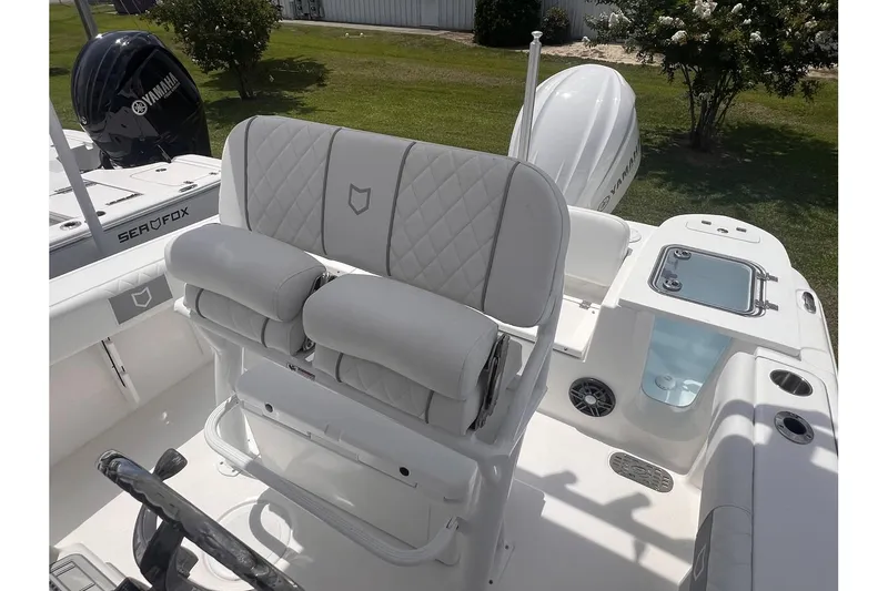 Slide: The Image of 2025 Sea Fox 228 boat interior with cushioned seating and Yamaha engine. - 10