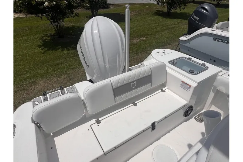 Slide: The Image of 2025 Sea Fox 228 boat interior with Yamaha engine, white seating, and storage compartments. - 6
