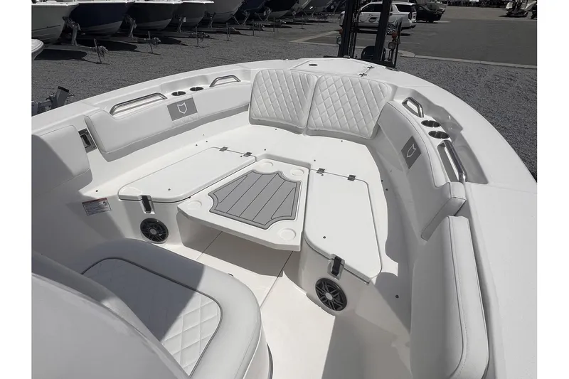 Slide: The Image of 2025 Sea Fox 228 boat interior with white cushioned seating and center table. - 8