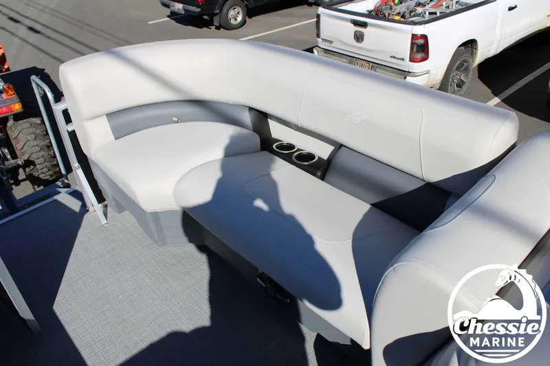 Slide: The Image of 2024 Starcraft Pontoon LX 22 R with plush seating and cup holders, displayed at Chessie Marine. - 10