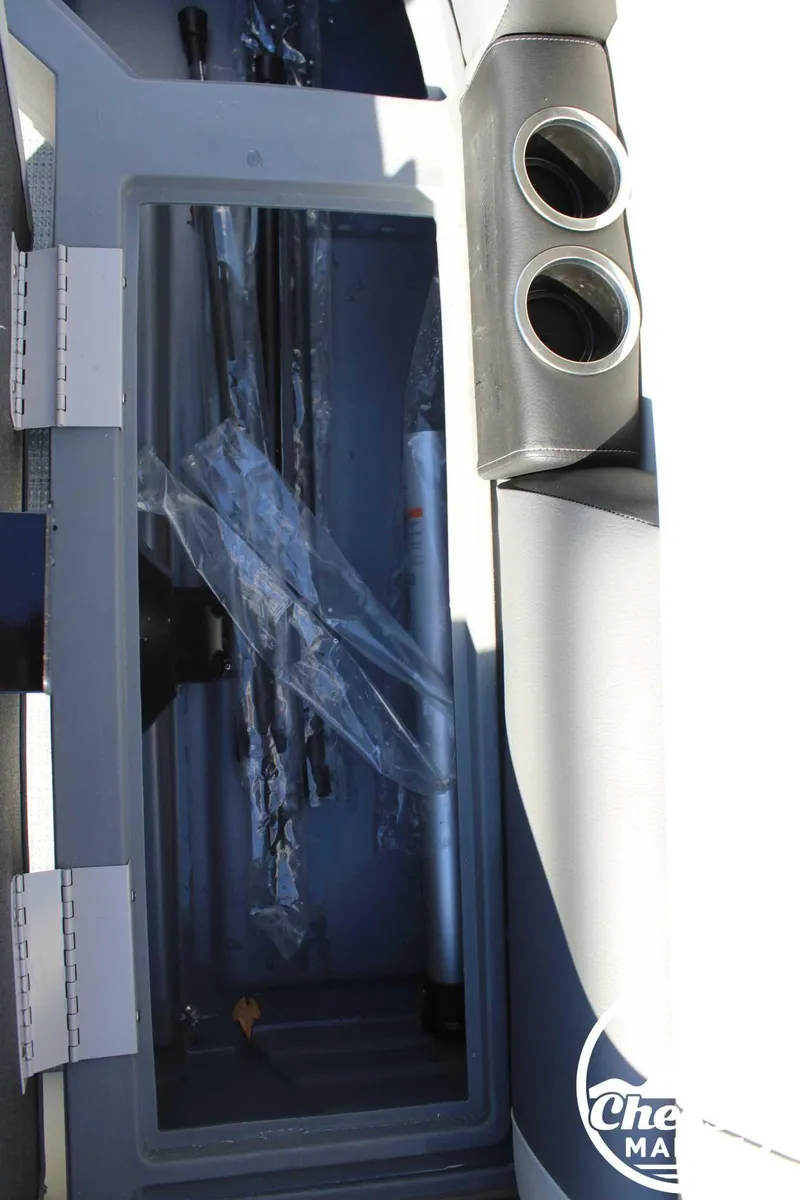 Slide: The Image of 2024 Starcraft Pontoon LX 22 R storage compartment with cup holders. - 12