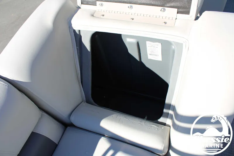 Slide: The Image of 2024 Starcraft Pontoon LX 22 R storage compartment with open lid, featuring cushioned seating. - 15