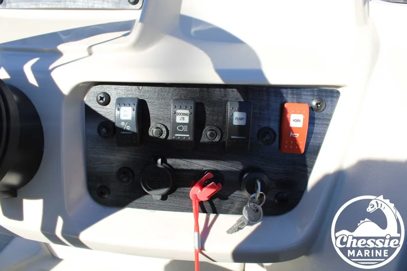 Slide: The Image of 2024 Starcraft Pontoon LX 22 R dashboard with switches and ignition keys. - 22