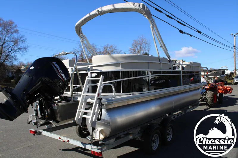 Slide: The Image of 2024 Starcraft Pontoon LX 22 R on trailer, featuring Mercury outboard motor. - 5