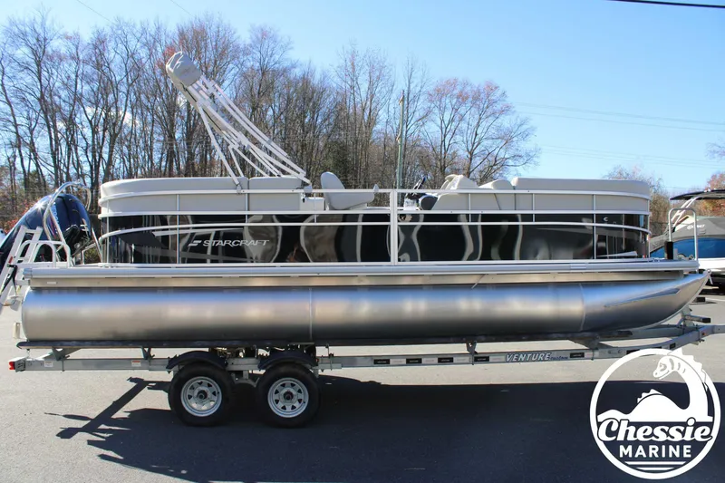 Slide: The Image of 2024 Starcraft Pontoon LX 22 R on trailer, displayed outdoors at Chessie Marine. - 6