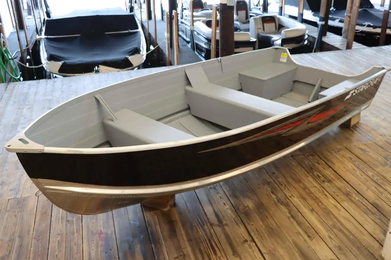 Slide: The Image of 2025 Starcraft 14 SF TS SS boat displayed on wooden dock indoors. - 4