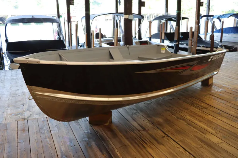 Slide: The Image of 2025 Starcraft 14 SF TS SS boat displayed on wooden dock indoors. - 5