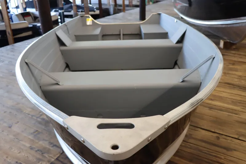 Slide: The Image of 2025 Starcraft 14 SF TS SS boat interior on wooden dock. - 6