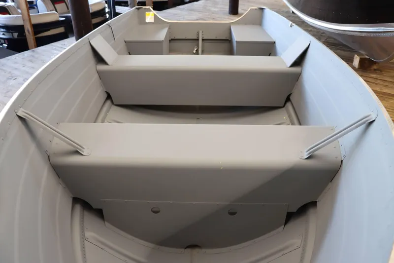 Slide: The Image of 2025 Starcraft 14 SF TS SS boat interior with seating and storage compartments. - 8