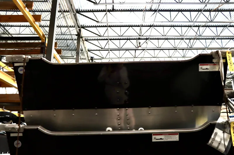 Slide: The Image of 2025 Starcraft 14 SF DLX TL boat hull in warehouse setting. - 4
