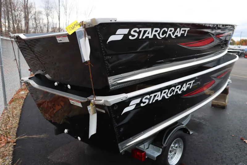 Slide: The Image of 2025 Starcraft 14 SF DLX TL boats stacked on trailer in outdoor setting. - 3