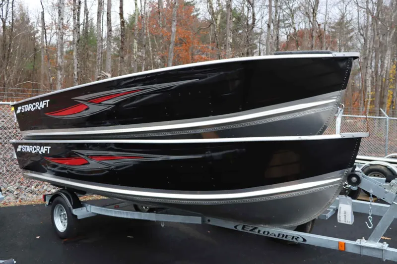 Slide: The Image of 2025 Starcraft 14 SF DLX TL boats on trailer in wooded area. - 4