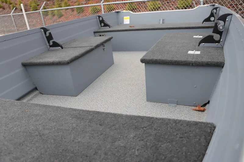 Slide: The Image of Interior of 2025 Starcraft 14 SF DLX TL boat with carpeted seating and storage. - 6