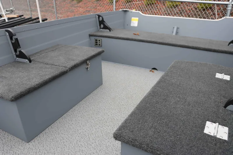 Slide: The Image of Interior of 2025 Starcraft 14 SF DLX TL boat with gray carpeted seating. - 7
