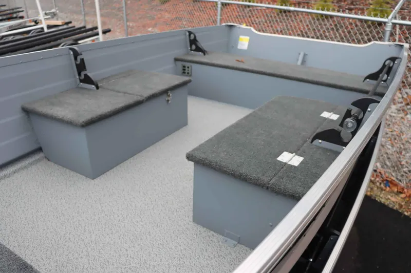 Slide: The Image of 2025 Starcraft 14 SF DLX TL boat interior with gray seating and storage compartments. - 8