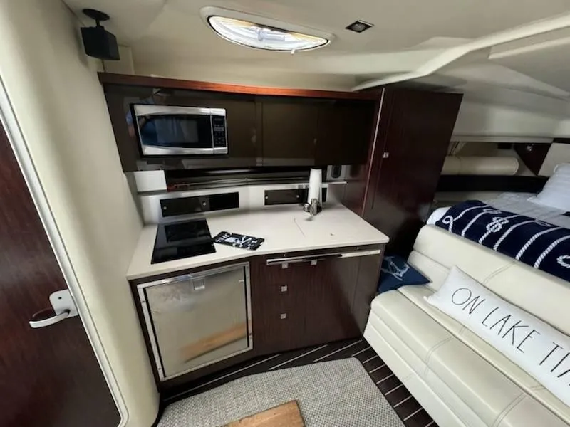 Slide: The Image of 2016 Monterey 355SY yacht interior with kitchenette and seating area. - 14