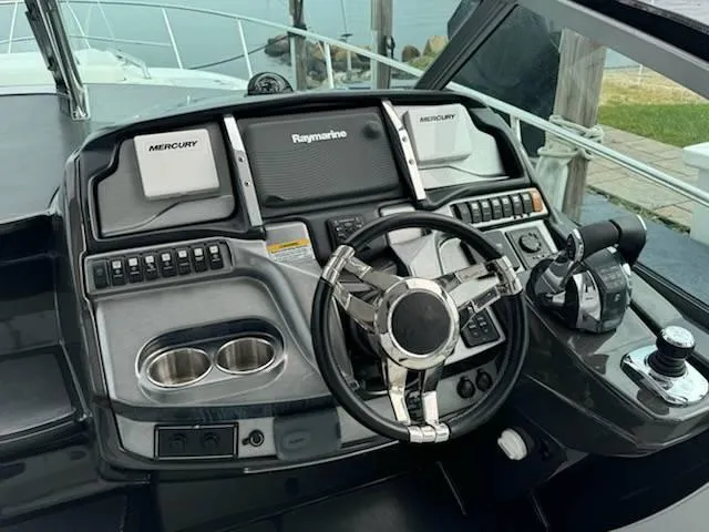 Slide: The Image of 2016 Monterey 355SY boat helm with Raymarine and Mercury controls. - 6