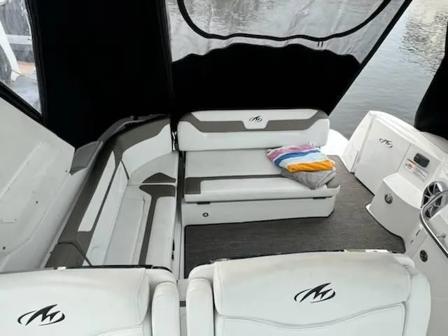 Slide: The Image of 2016 Monterey 355SY boat interior with cushioned seating and colorful towels. - 7