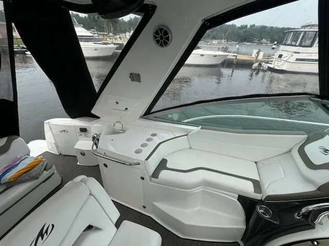 Slide: The Image of Interior of a 2016 Monterey 355SY yacht with sleek white seating and marina view. - 8