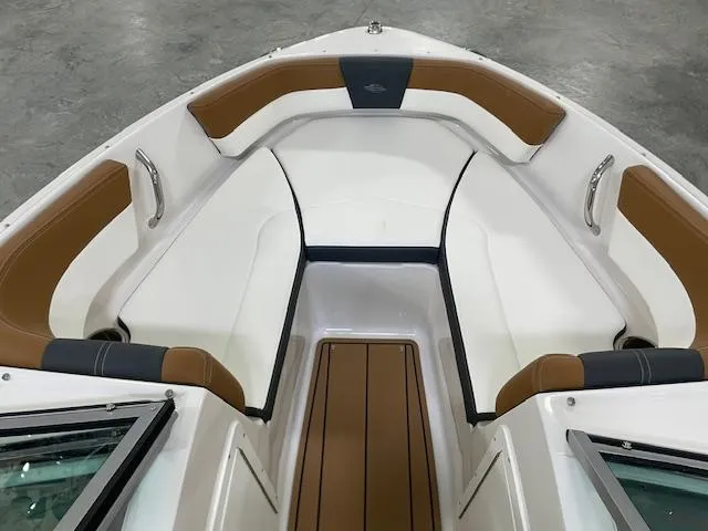 Slide: The Image of 2025 Chaparral 19 SSi OB boat interior with brown and white seating. - 10