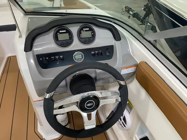 Slide: The Image of 2025 Chaparral 19 SSi OB boat dashboard with steering wheel and Yamaha gauges. - 11
