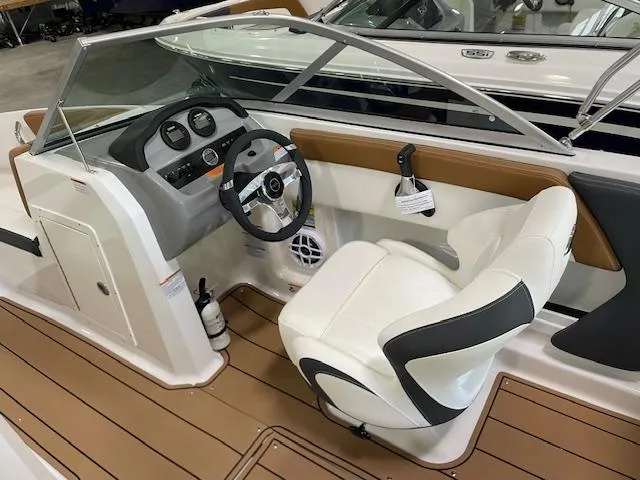 Slide: The Image of 2025 Chaparral 19 SSi OB boat interior with steering wheel and white seating. - 12