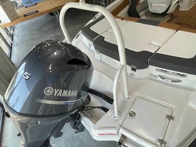 Slide: The Image of 2025 Chaparral 19 SSi OB boat with Yamaha outboard motor in a garage. - 13