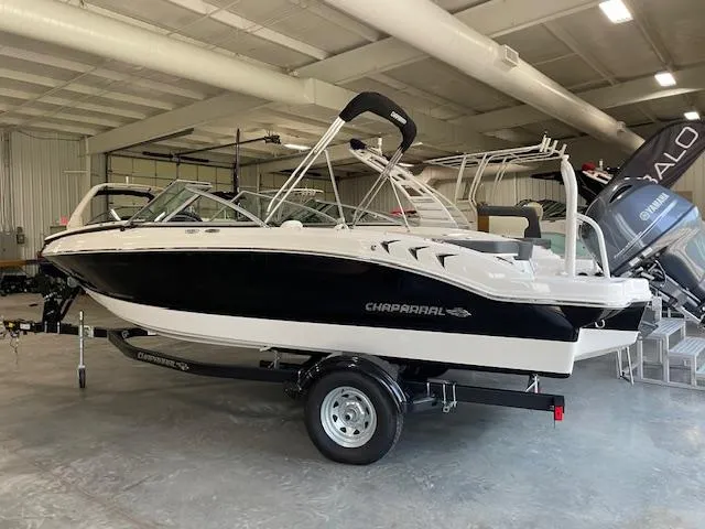 Slide: The Image of 2025 Chaparral 19 SSi OB boat in showroom, black and white design. - 3