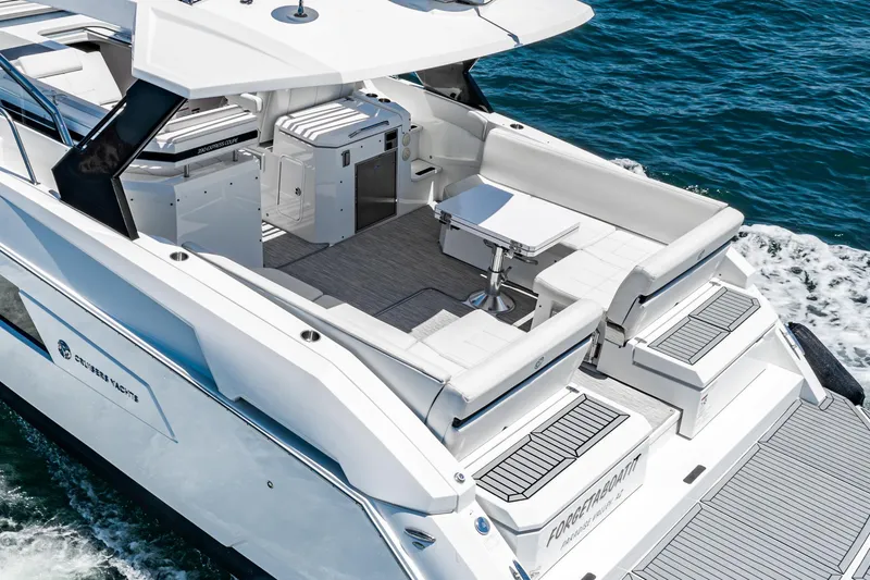 Slide: The Image of 2017 Cruisers Yachts 390 Express Coupe, luxury boat on water, featuring spacious deck and seating. - 14