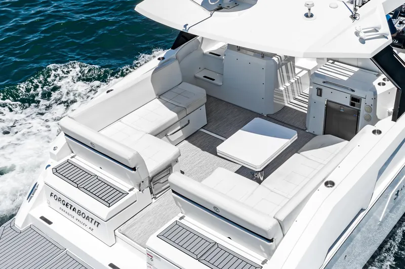Slide: The Image of 2017 Cruisers Yachts 390 Express Coupe, spacious deck, luxurious seating, cruising on water. - 15