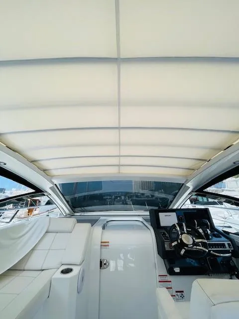 Slide: The Image of 2017 Cruisers Yachts 390 Express Coupe interior with helm and seating area. - 24