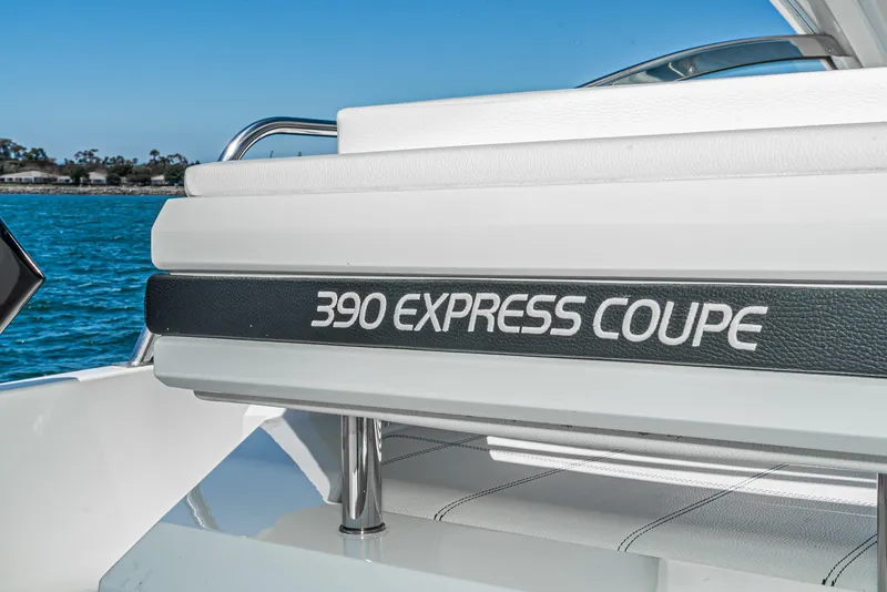 Slide: The Image of 2017 Cruisers Yachts 390 Express Coupe, white seating, ocean backdrop. - 27