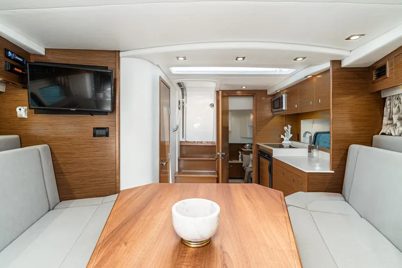 Slide: The Image of Interior of 2017 Cruisers Yachts 390 Express Coupe, featuring modern wood finishes and seating. - 30