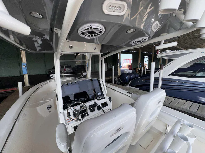 Slide: The Image of 2022 Cobia 280 Center Console boat interior with modern dashboard and seating. - 12