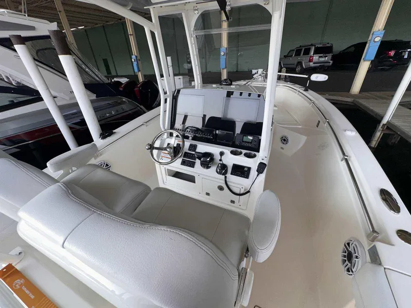 Slide: The Image of 2022 Cobia 280 Center Console boat interior with steering wheel and controls. - 13